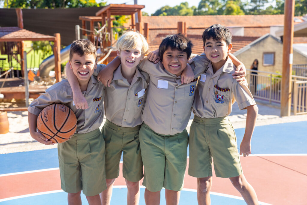 Students standing together on a school sports court, representing belonging, friendship and diversity within a values‑based school community.
